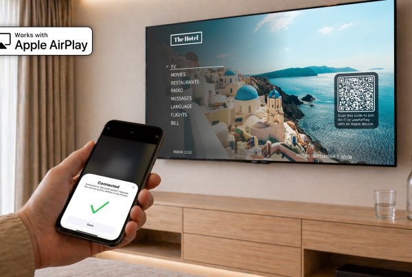 Hotel room TV with Nonius TV+ streaming via Apple AirPlay from iPhone, showing seamless wireless casting without external hardware